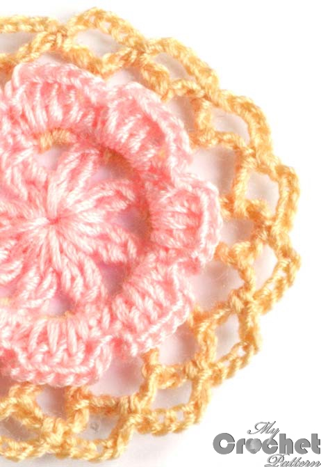 Round crochet motif with flower in the center photo preview